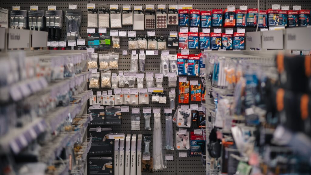 Hyllor med verktygstillbehör, lim, fästdon och smådelar i en järn- och heminredningsbutik.
